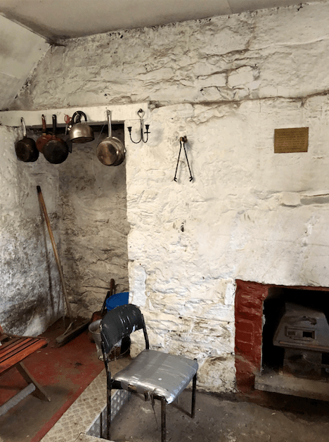 Pots and pans and fireplace inside the Ryvoan Pass bothy 