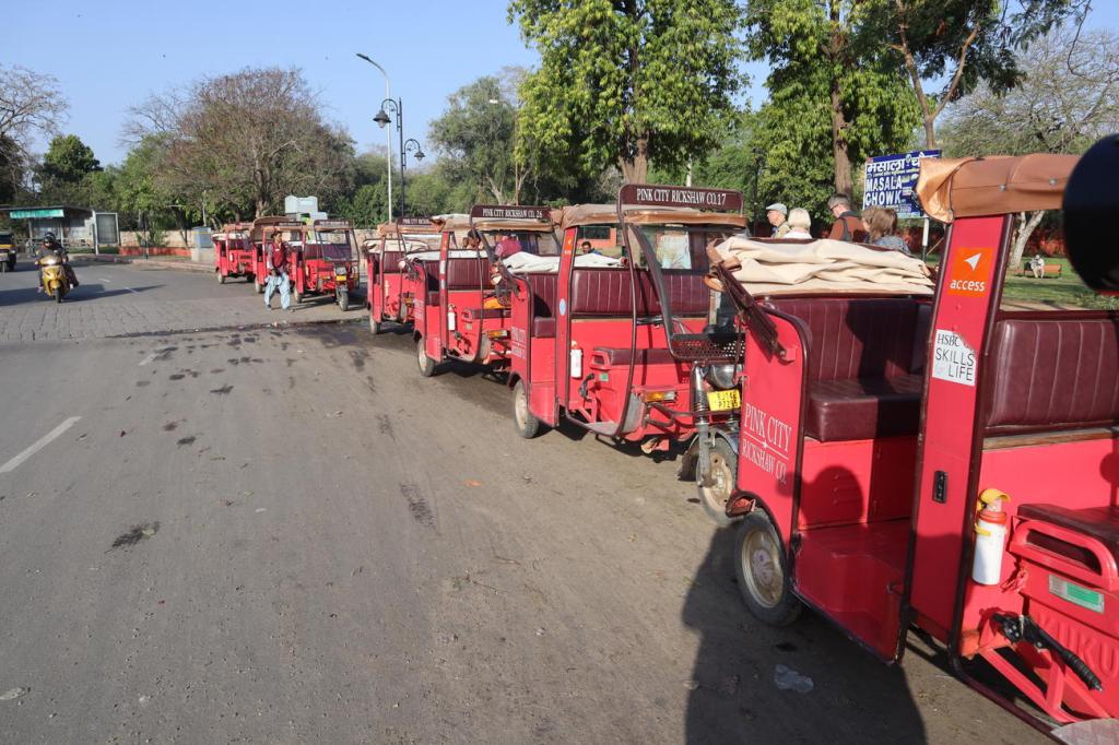 A line of pink rickshaws